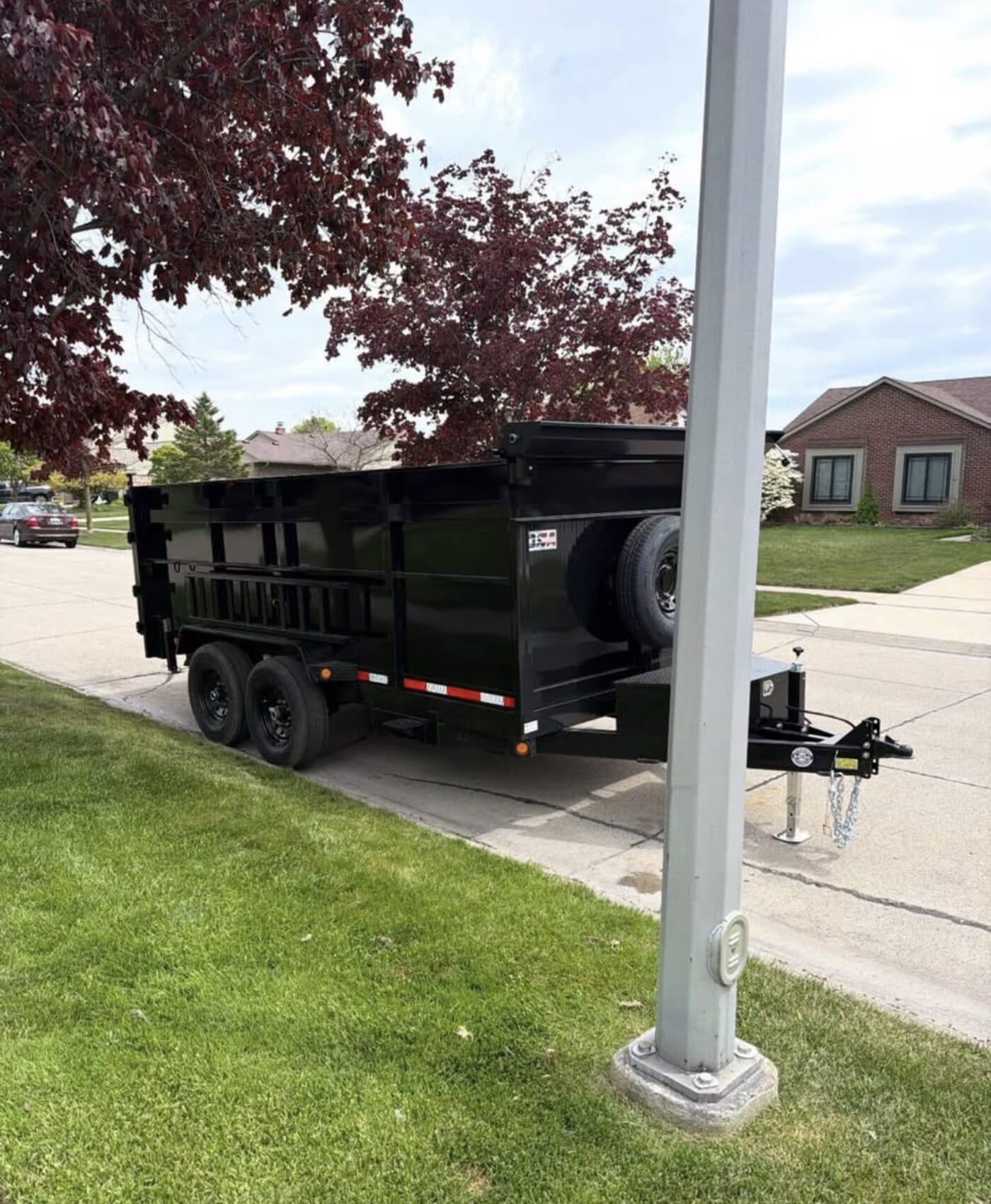 The 7x14 dump trailer parked in a residential driveway