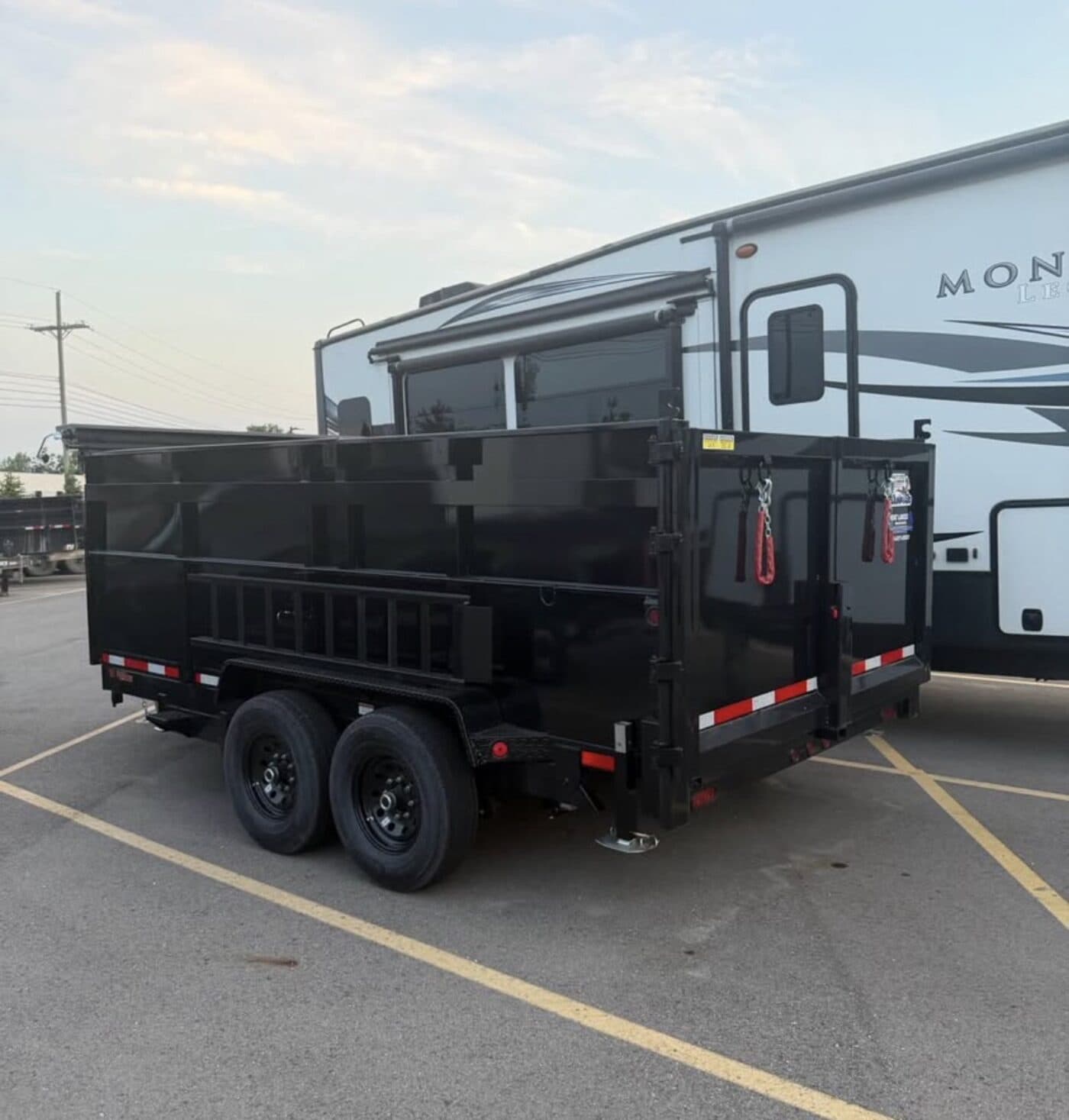 Rear view of the dump trailer with barn doors and ramps